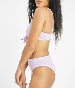 The Ruched Plunge Bralette & Bikini Swim Bundle: Lilac -Wear Lively Shop 3 on model side swim ruched high waist bikini bottom lilac 24c3ca57 d05b 4db6 bcd3 88681af950fc